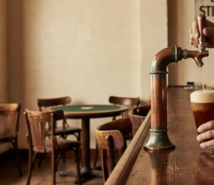 Craft beer being poured in the brew house at AGNIESZKA ADACH WERSA